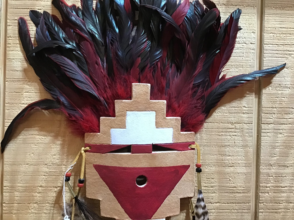 painted mask with feathers